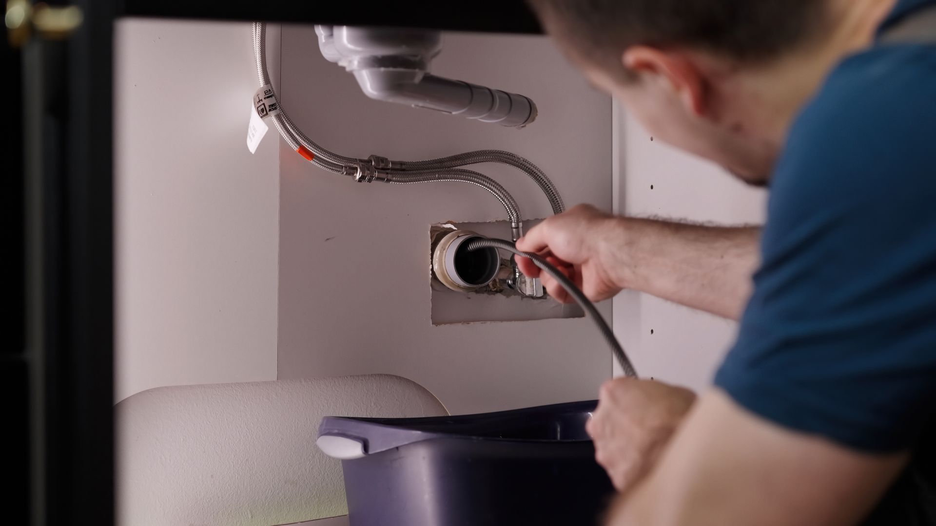 Plumber snaking a drain